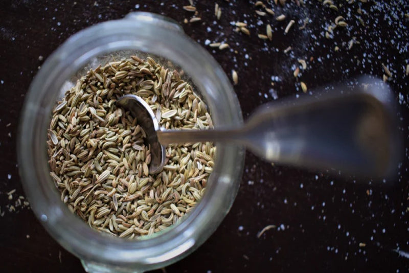Flax seeds in a jar with a metal spoon inside