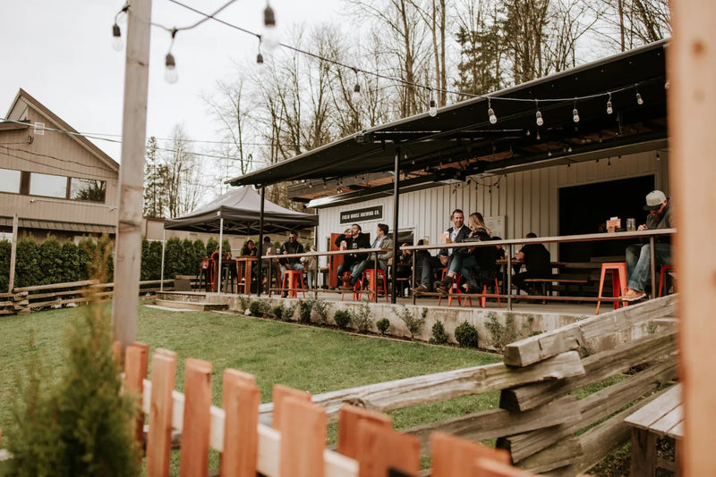 Field House Brewing Co outdoor patio with fenced in lawn for dogs