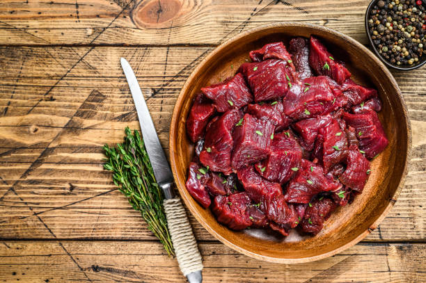 Wooden bowl full of cubed, raw venison