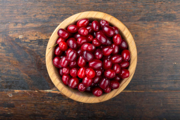Wooden bowl full of fresh cranberries